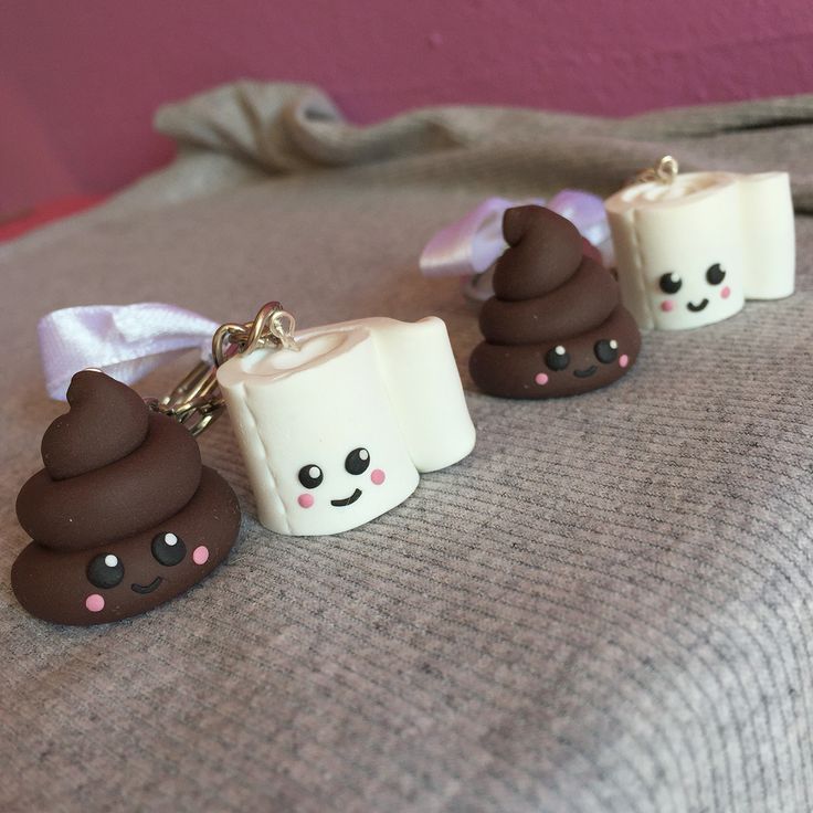 three chocolate covered marshmallows sitting on top of a bed next to each other