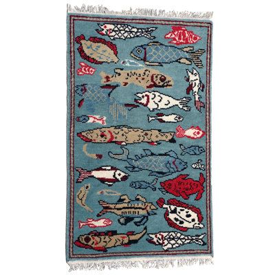 a blue rug with fish on it