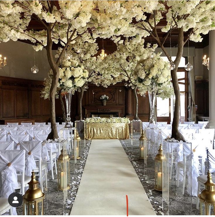 the aisle is lined with white flowers and gold candles for an elegant wedding ceremony at the grand america hotel