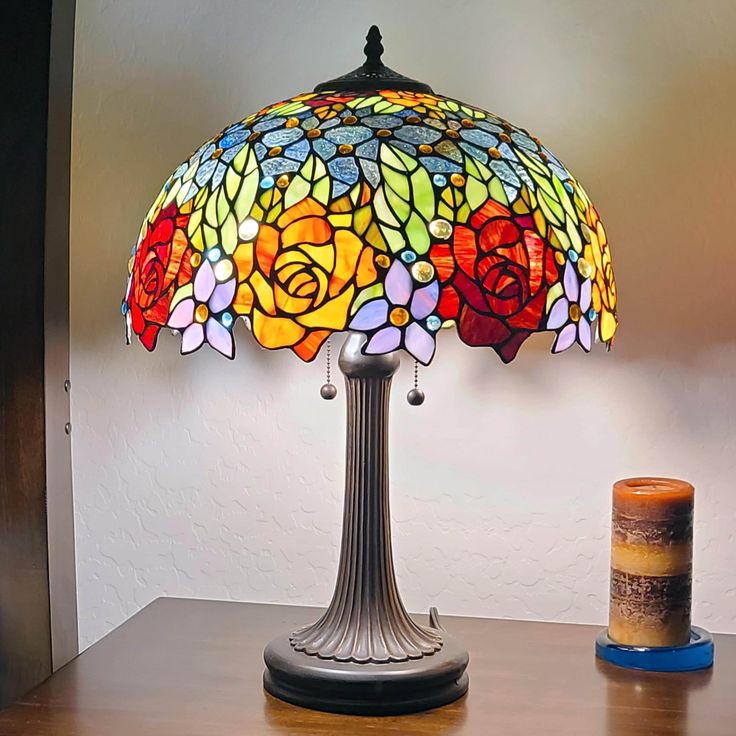 a stained glass lamp sitting on top of a wooden table