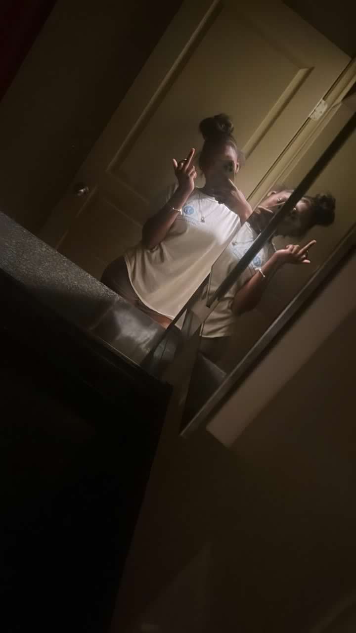 two people standing in front of a mirror with their hands out to each other and one person taking a selfie