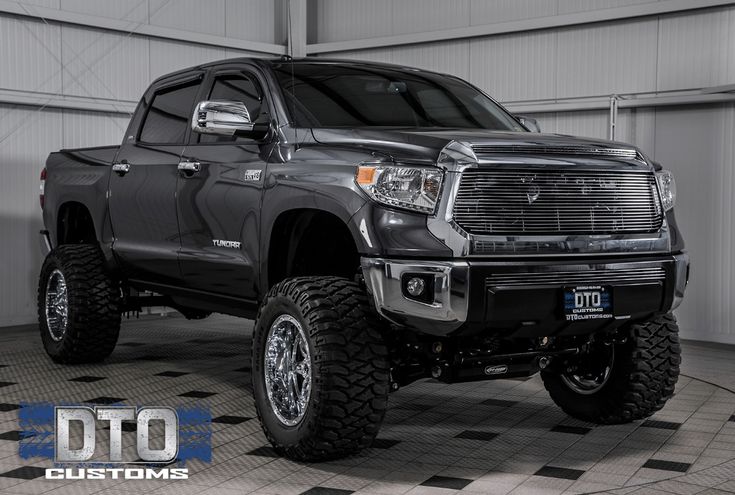 a large black truck parked in a garage