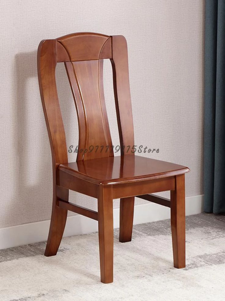 a wooden chair sitting on top of a carpeted floor