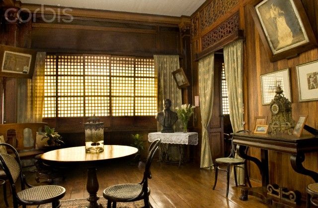 an old fashioned dining room with wood paneled walls and wooden flooring, along with pictures on the wall