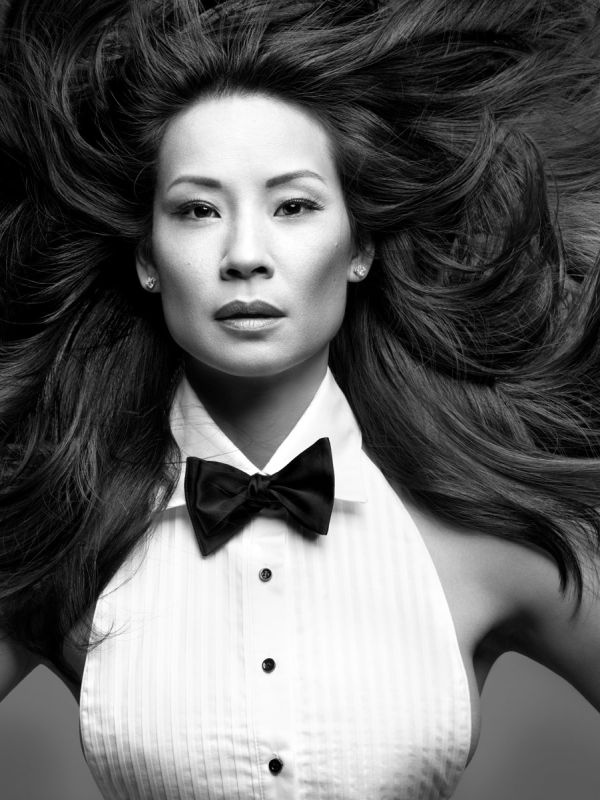 a woman with long hair wearing a bow tie