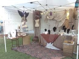 an outdoor tent with clothes on display and other items in baskets under the awning