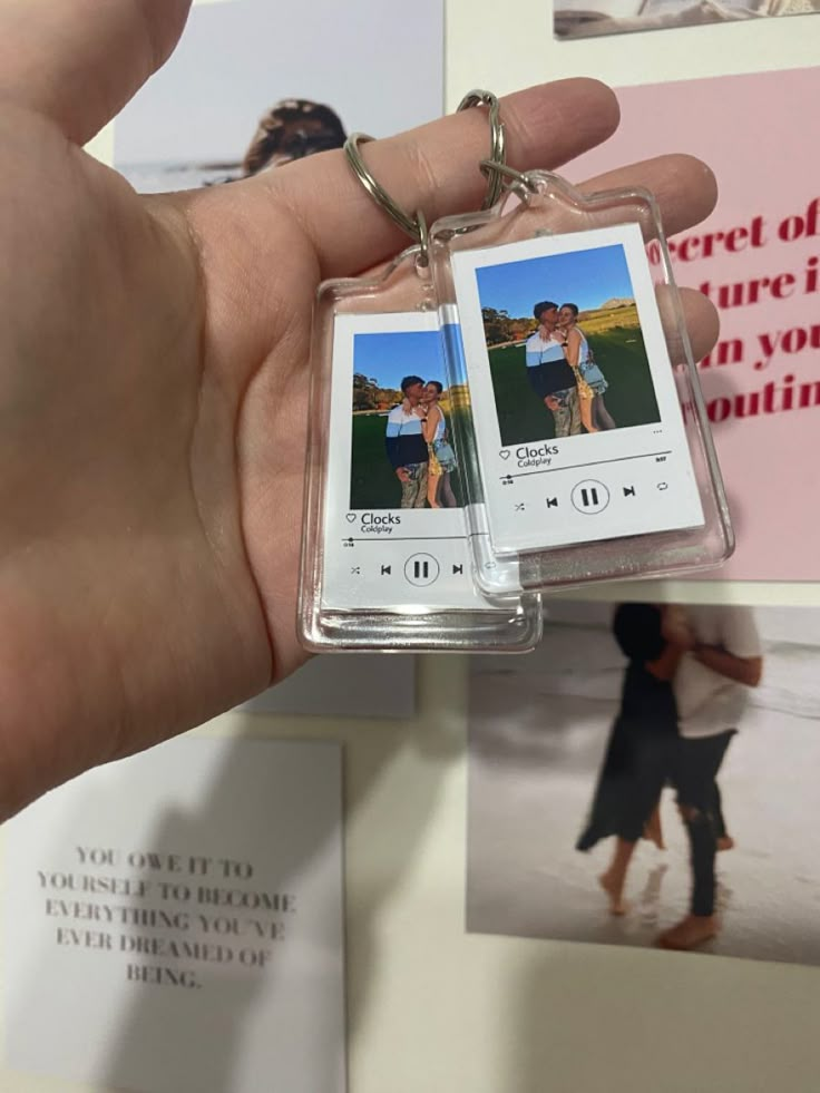 a hand holding an mp3 player with two pictures on it