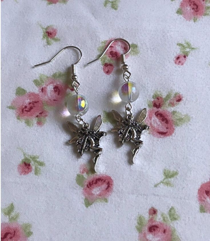 ✨Gorgeous holographic fairy earrings, these reflect a pinkish/rainbow aura upon wearing. These earrings are made with metal safe for sensitive ears <3 perfect for any occasion and also a very heartfelt gift for your fairy friends 💗✨  Fairycore, Handmade Jewelry, y2k, Fairy Earrings, Aura, Whimsical Jewelry, Cottagecore Jewelry  All jewelry orders come with a custom care guide⭐️ For any questions, please message me! Silver Fairycore Earrings For Party, Fairycore Earrings For Pierced Ears For Party, Nickel-free Fairycore Earrings For Jewelry Making, Fairy Jewelry Earrings, Fairy Earrings, Fairy Grunge Silver Earrings For Gift, Fairycore Silver Earrings For Gift, Silver Fairy Grunge Earrings For Gift, Silver Fairy Style Dangle Earrings