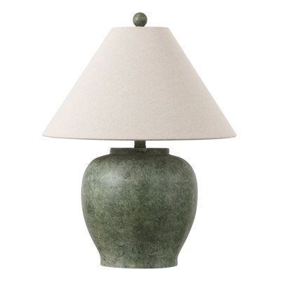 a green ceramic lamp with a white shade on the base and a light bulb at the end