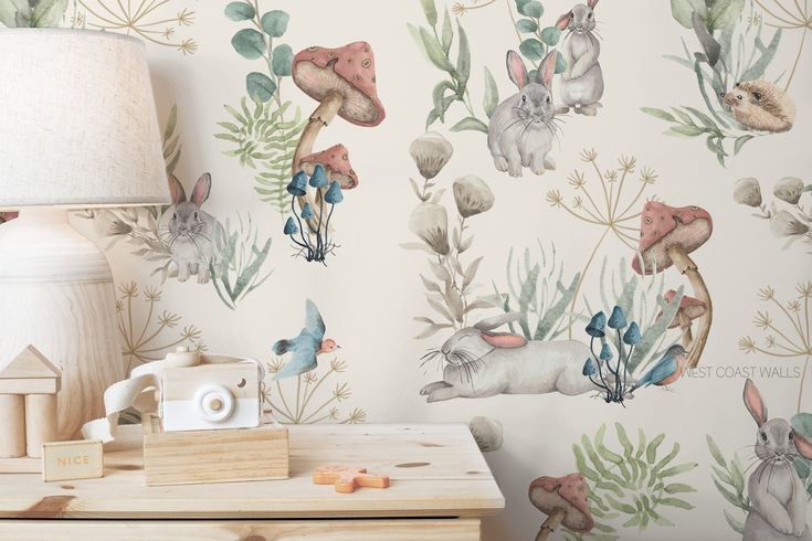 an animal themed wallpaper in a child's room with a lamp on the side table