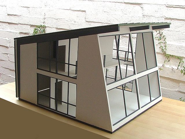 a model house made out of cardboard sitting on top of a table