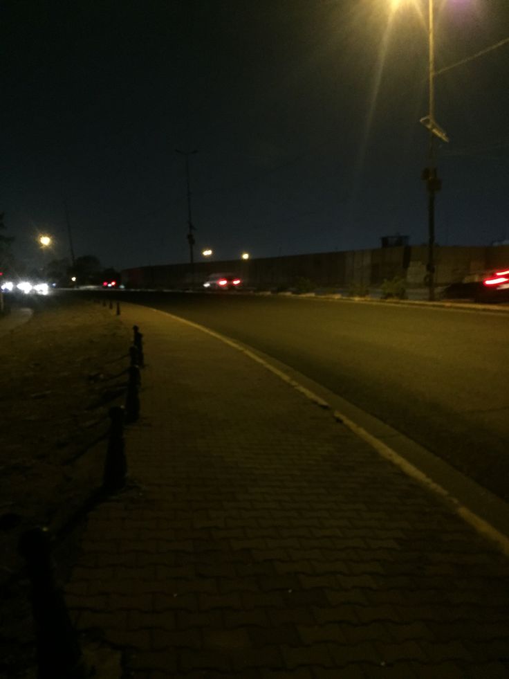 an empty street at night with the lights on