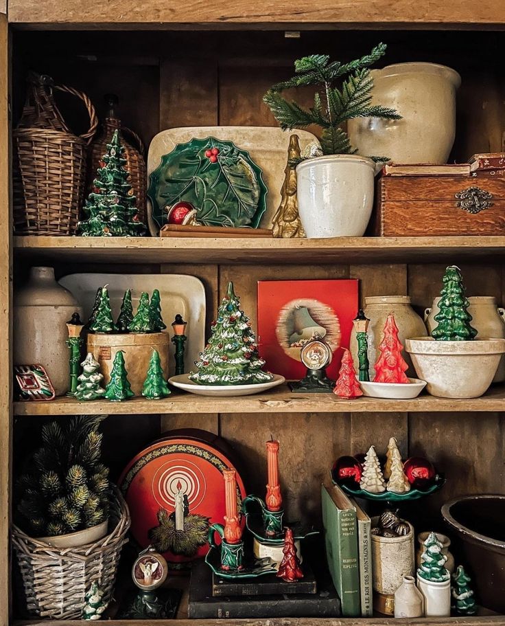 a wooden shelf filled with christmas decorations and other items