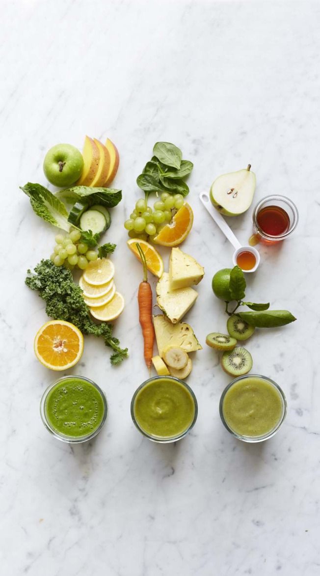 various fruits and vegetables are arranged on a marble surface