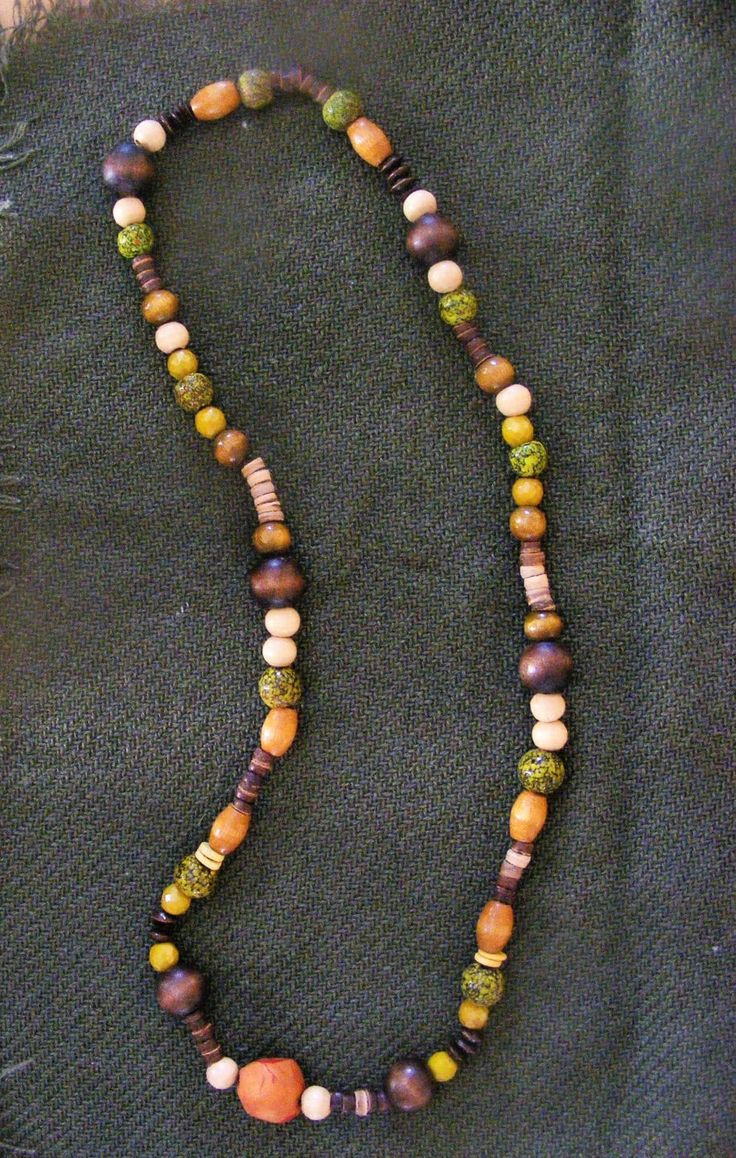 This necklace has it all - wood, beads, seeds, and clay - in soothing shades of green and brown naturals. Nature-inspired Brown Necklaces With Natural Variations, Nature-inspired Brown Necklace With Natural Variations, Earthy Multicolor Beaded Necklace, Earthy Brown Beaded Necklaces, Nature-inspired Brown Beaded Necklaces, Nature-inspired Brown Beaded Necklace, Earthy Multicolor Wooden Beaded Necklaces, Nature-inspired Green Jewelry With Wooden Beads, Earthy Green Necklace With Wooden Beads