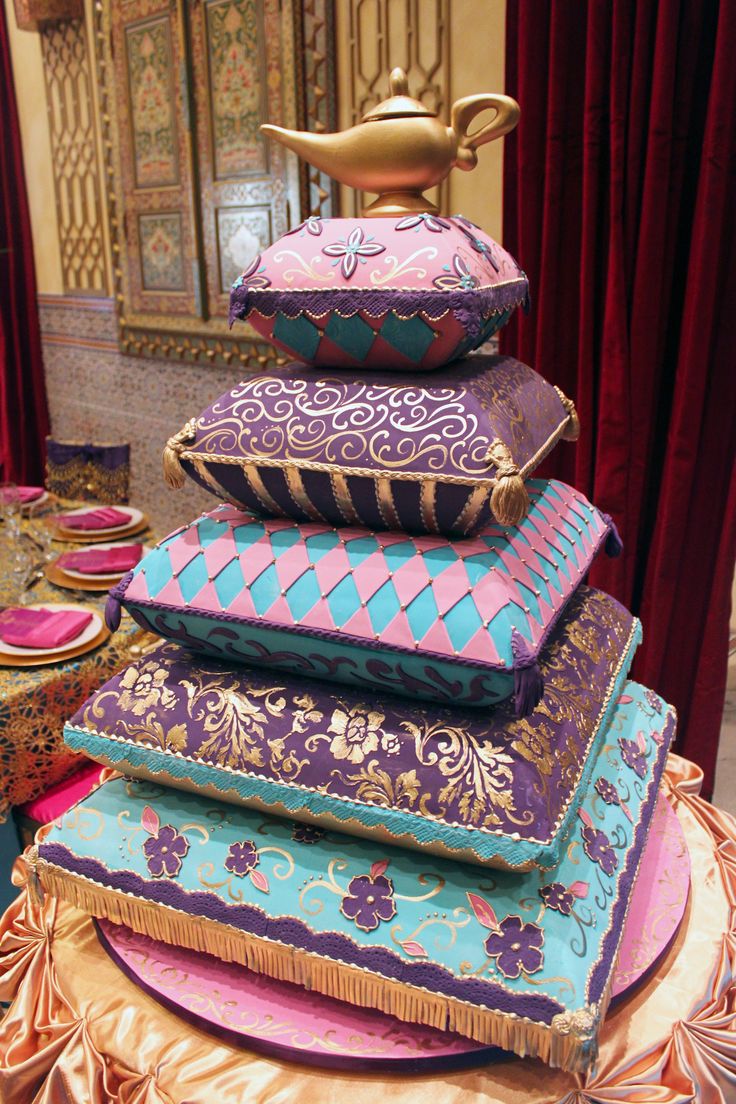 a stack of decorative pillows sitting on top of a table