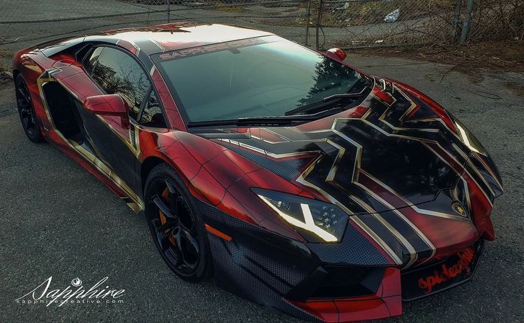 a red and black sports car parked in a parking lot