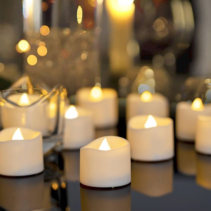 many white candles sitting on top of a table