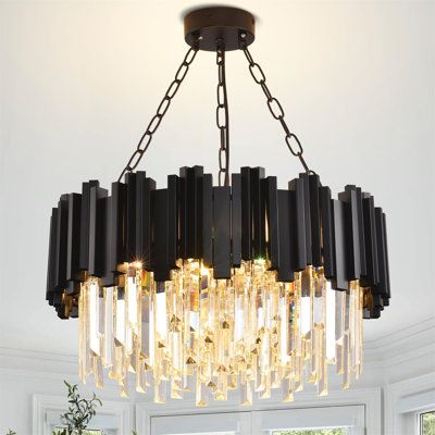 a chandelier hanging over a dining room table