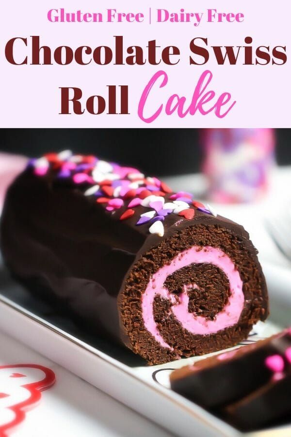 chocolate swiss roll cake with pink frosting and sprinkles on the top