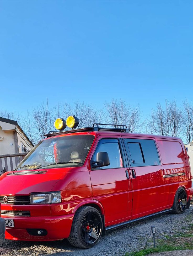 a red van parked in front of a house