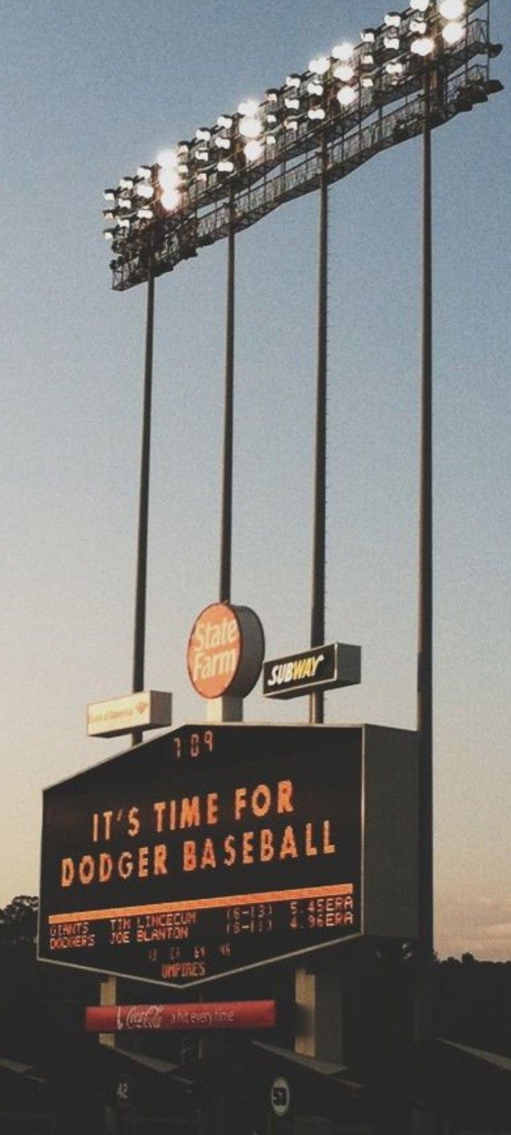 a baseball stadium sign with lights on it's top and the words dodger base ball