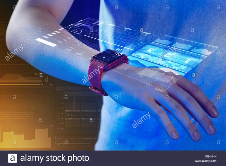 a man holding an electronic device in his hands with futuristic technology on the screen - stock image