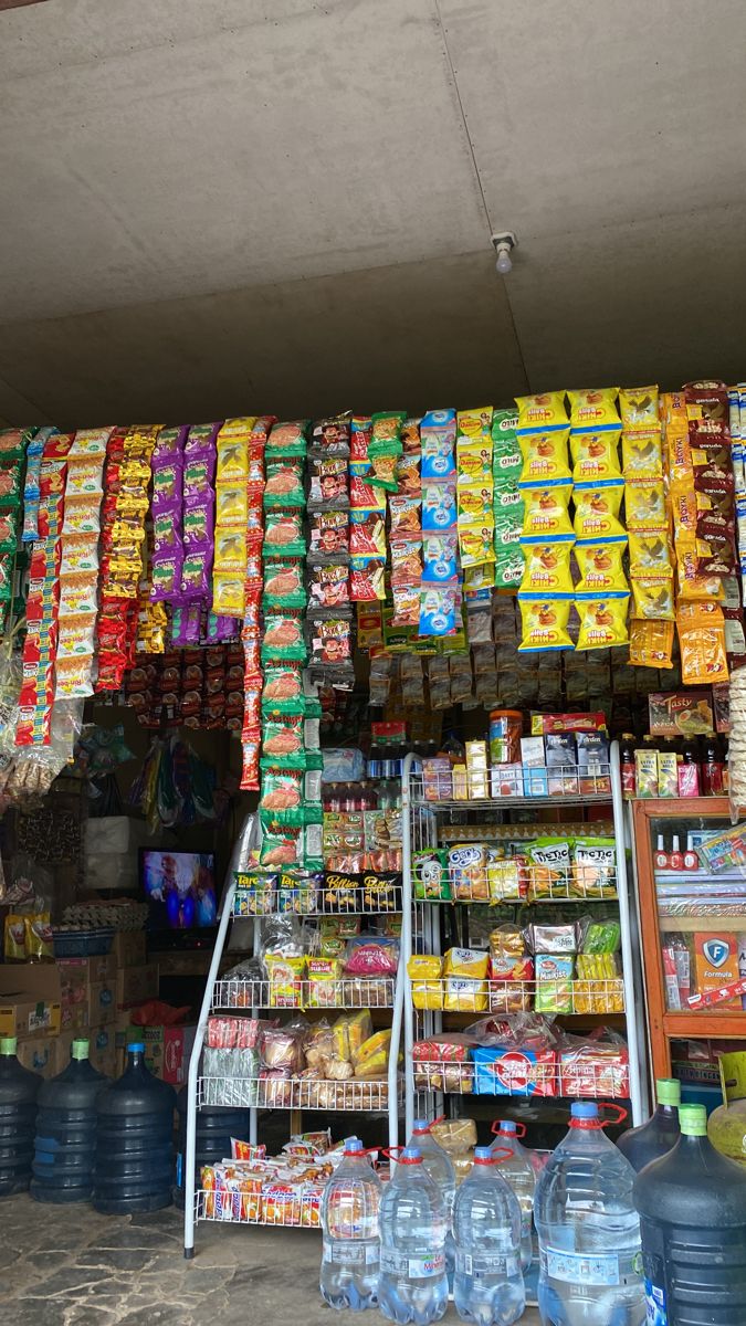 a store filled with lots of different types of food and water bottles next to each other