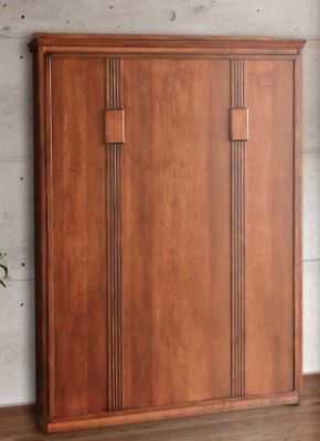 a large wooden cabinet sitting on top of a hard wood floor next to a plant