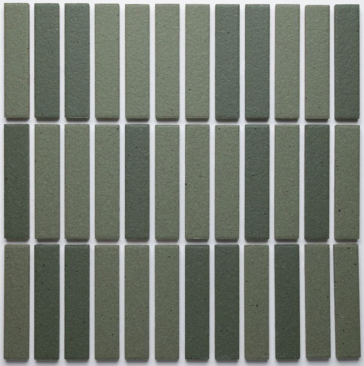 green tiles are arranged in rows on a white surface, with small squares at the top