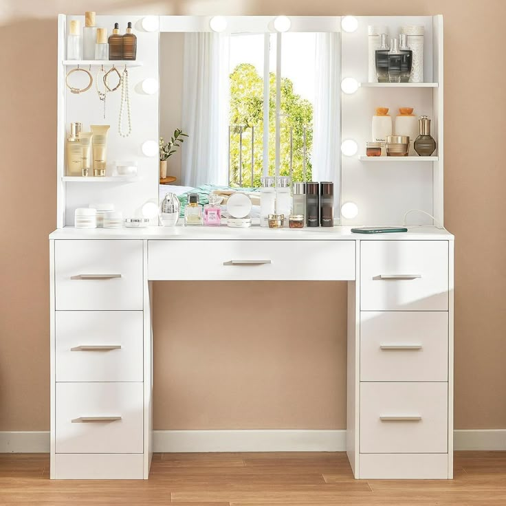 a white vanity with lights on it in front of a window