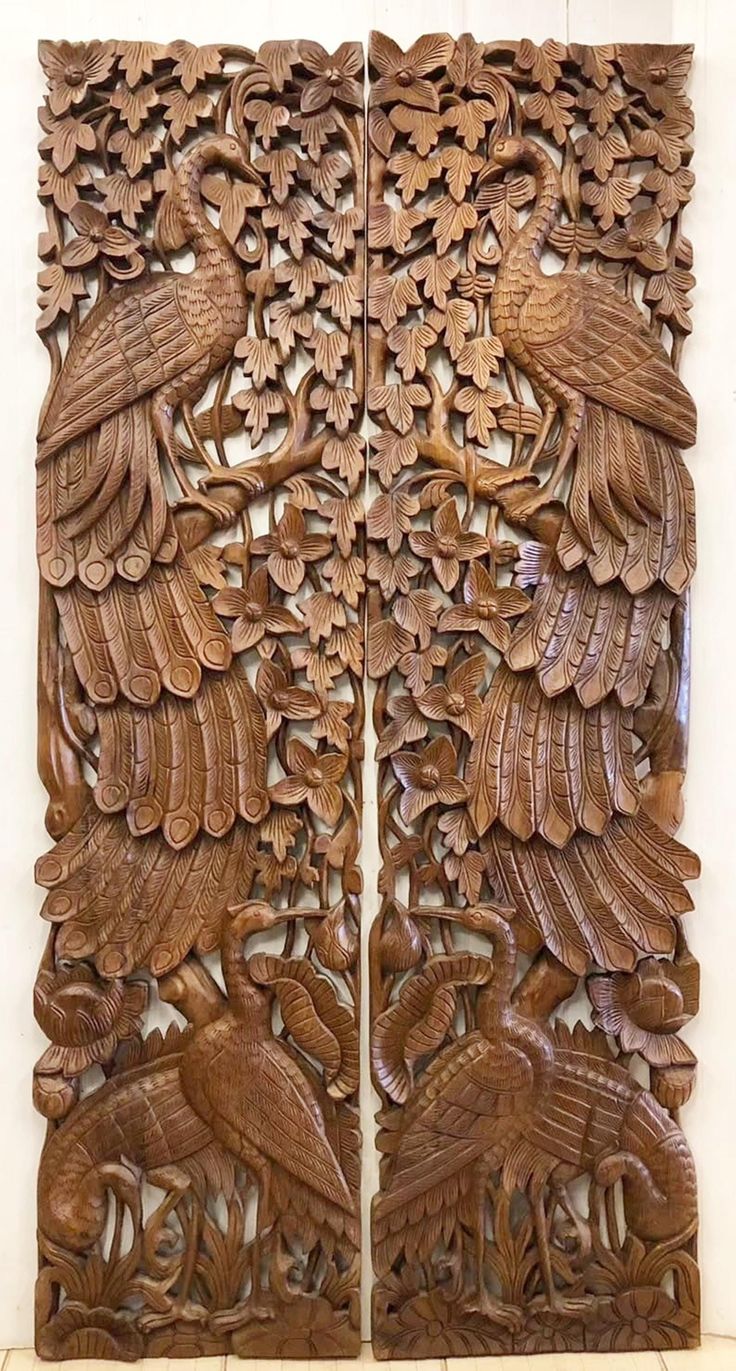 two carved wooden panels with birds on them