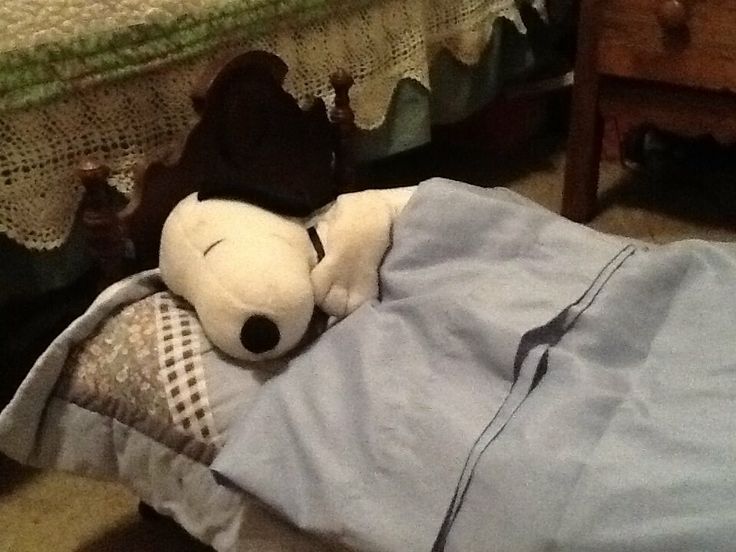 a stuffed animal laying on top of a bed