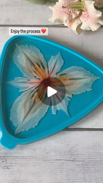 a blue tray with a flower painted on the side and an empty video player next to it