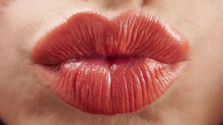 a woman's lips with red lipstick on them