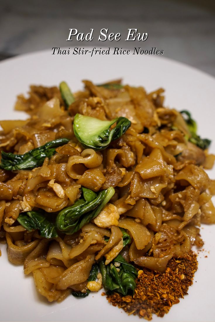 a white plate topped with noodles and vegetables