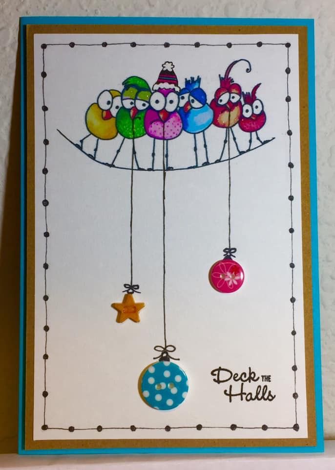 a card with birds and balls hanging from strings