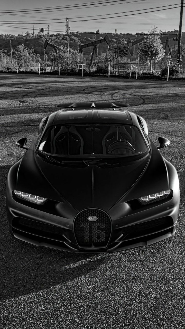 a black bugatti is parked in the parking lot