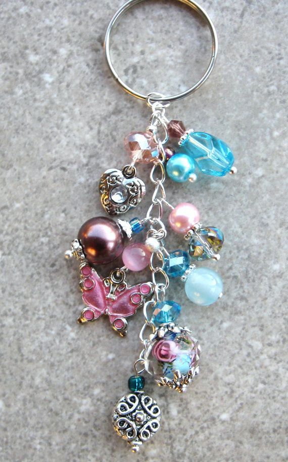 a keychain with many different beads and charms hanging from it's side