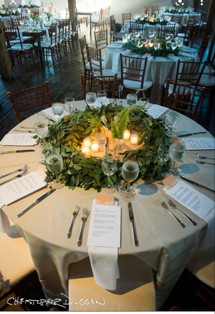 the table is set with place settings and candles