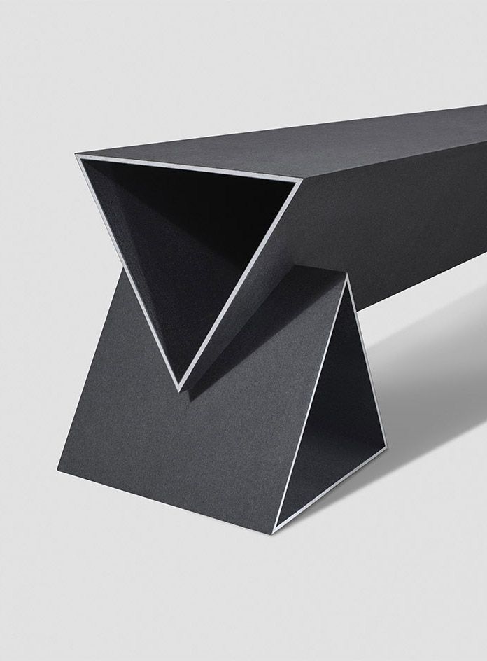 a black table with an angled design on it's top and the bottom section is folded in half