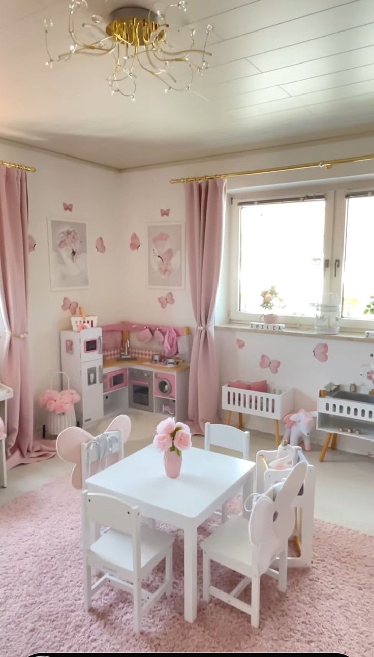 a child's room with pink carpet and white furniture, including a table and chairs