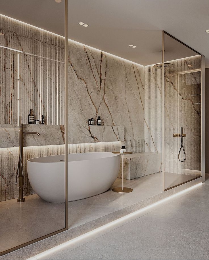 an elegant bathroom with marble walls and flooring, along with a freestanding bathtub