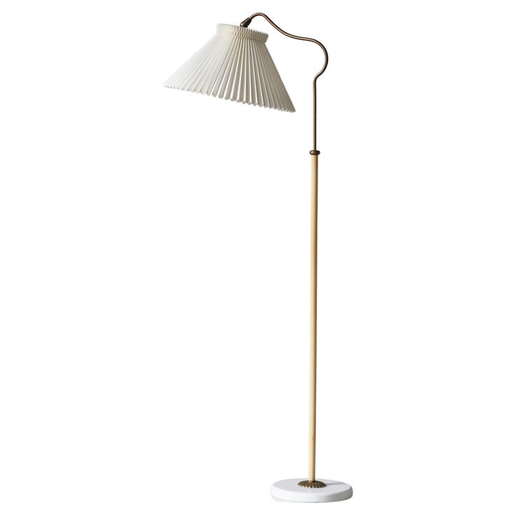 Rare and beautiful Danish Modern adjustable floor lamp model "G109" in brass manufactured in the 1940s by LYFA, Copenhagen and attributed to Bent Karlby. The brass stem can be adjusted in height (123-158 cm) and can be turned 360 degrees. The lamp is mounted with a hand folded shade by Le Klint. LYFA has since the 1930s won multiple international design awards for their spectacular lamps such as the Gold Medal at the World Fair 1929 in Barcelona and once again in 1935 in Brussels for the RA pend Scandinavian Floor Lamp, Le Klint, Brass Floor, Adjustable Floor Lamp, International Design, Brass Floor Lamp, Gold Medal, Floor Lamp Lighting, History Design