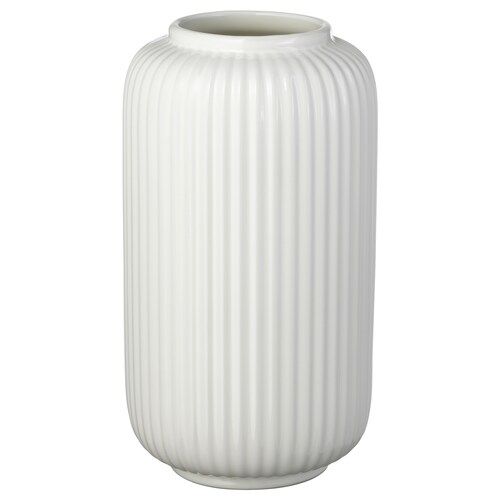 a large white vase sitting on top of a table