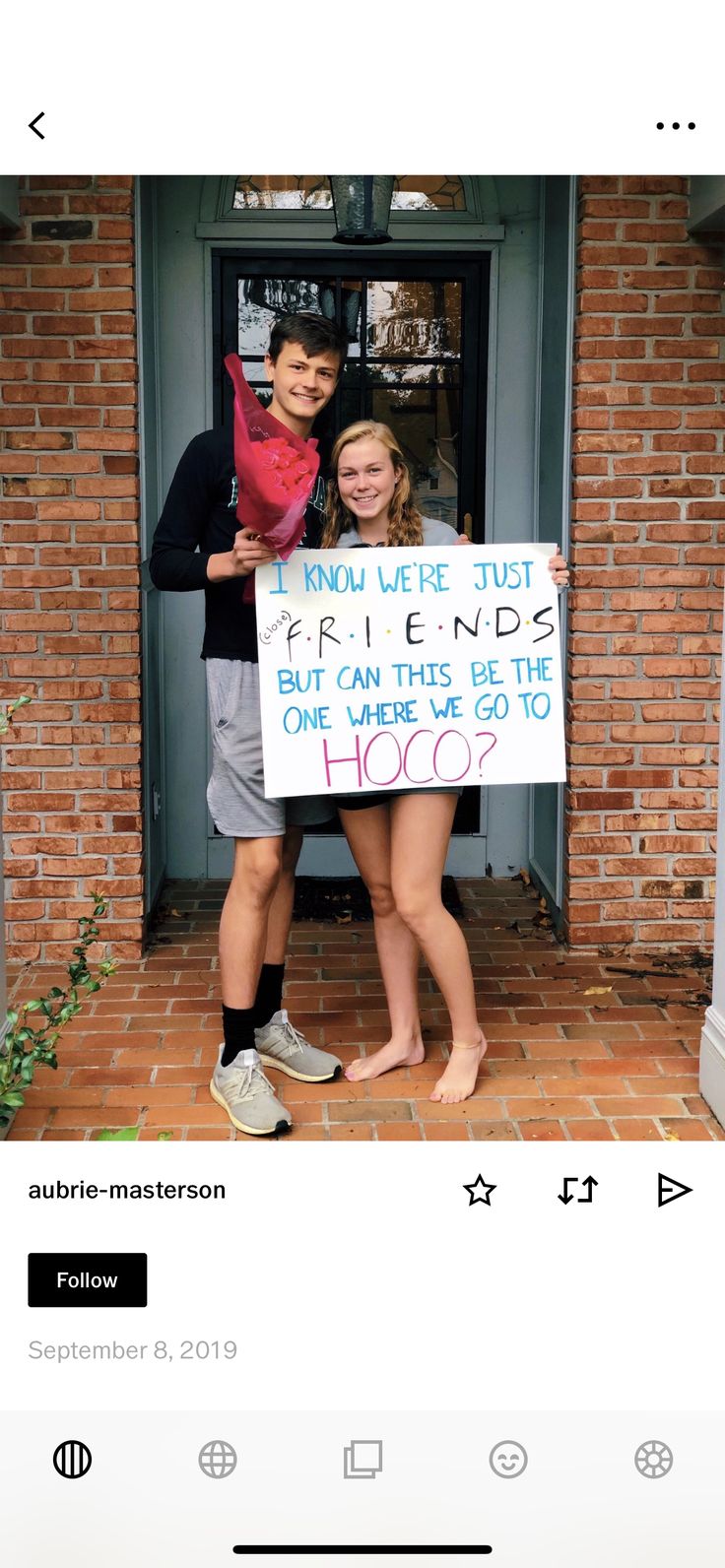 two people standing in front of a brick building holding a sign that says friends but can this be the end of hoos?