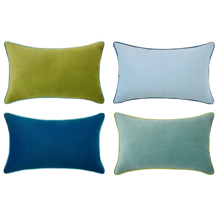 four pillows in different colors on a white background