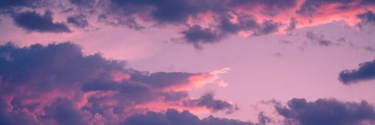 the sky is filled with pink and purple clouds