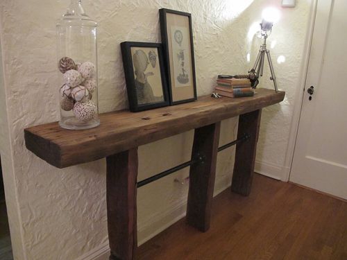 a wooden table with two framed pictures on it