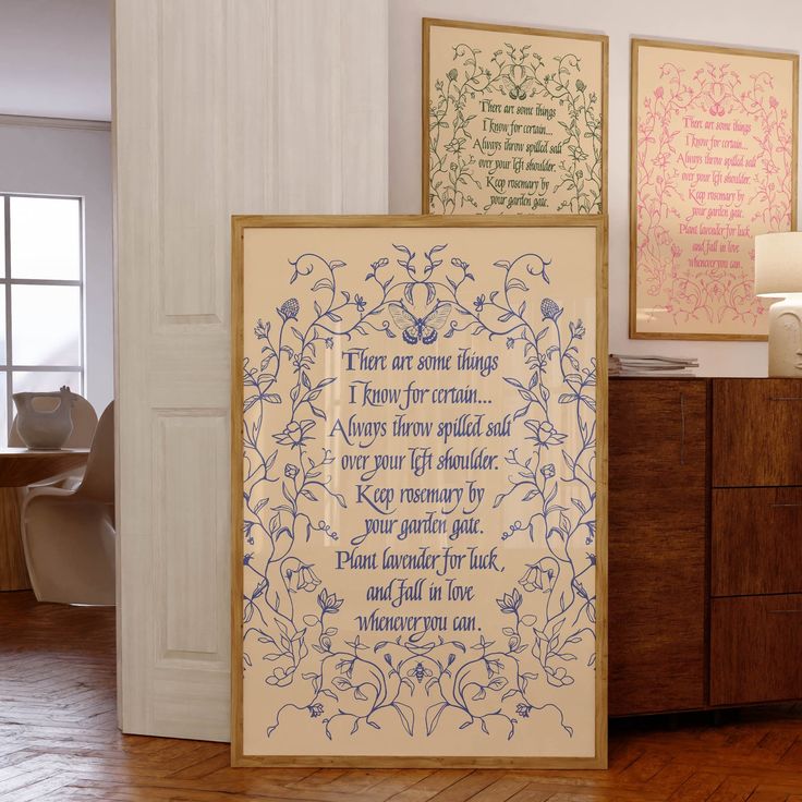 two framed art pieces in a room with wood flooring and white walls, one has a poem on it